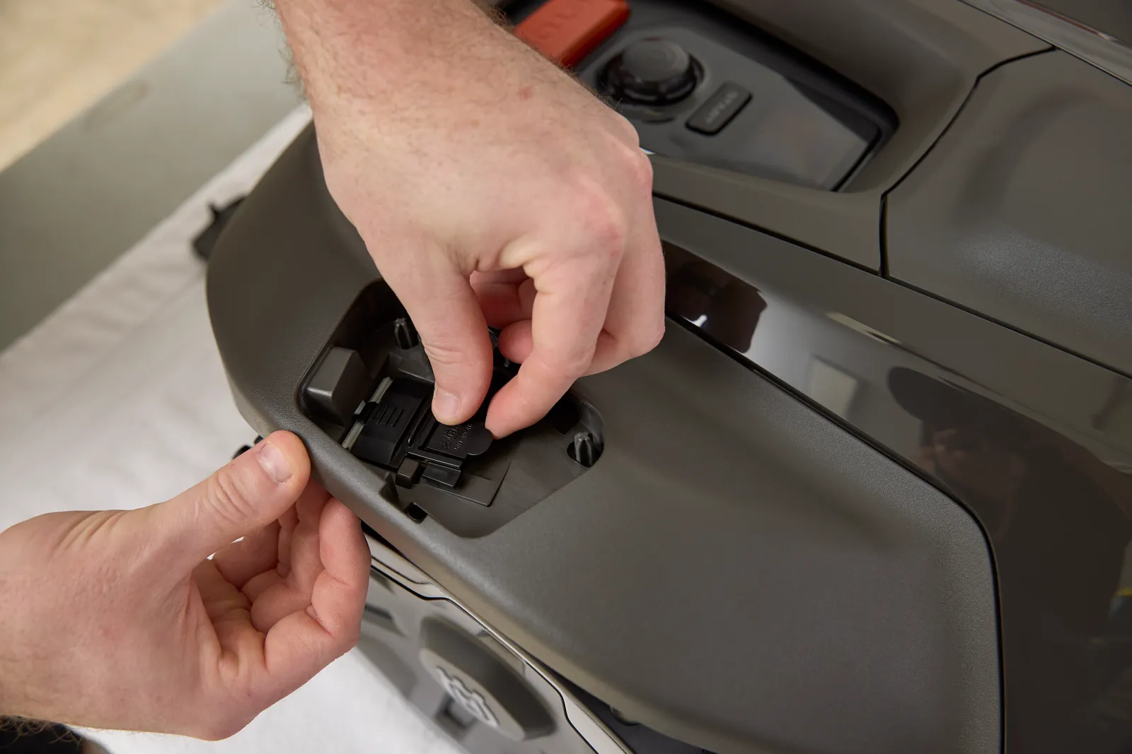 A component being fitted to a robotic mower